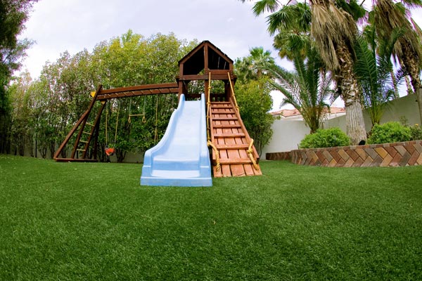 Slide installed on artificial playground grass from SYNLawn