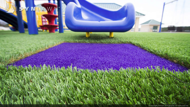 Blue slide installed on artificial grass