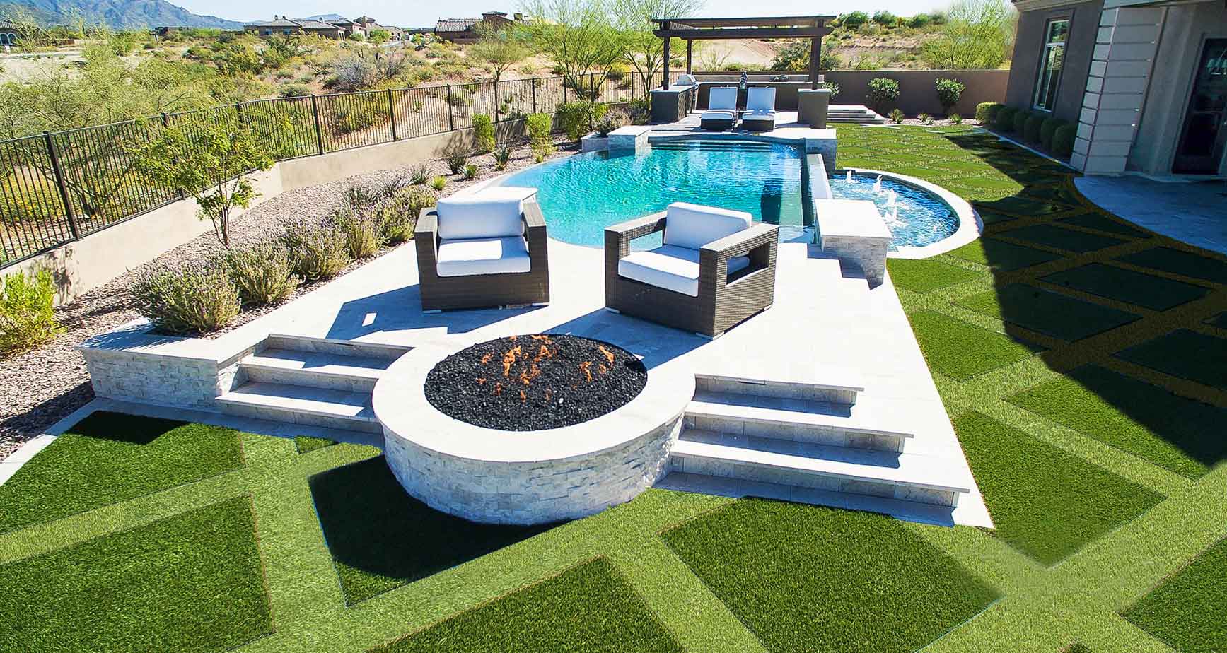 Artificial grass backyard with pool and fire pit area