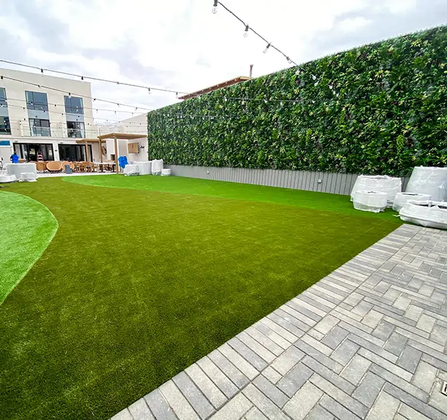 Artificial grass courtyard area with synthetic living wall